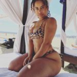 Très belle black en maillot léopard sur lit baldaquin